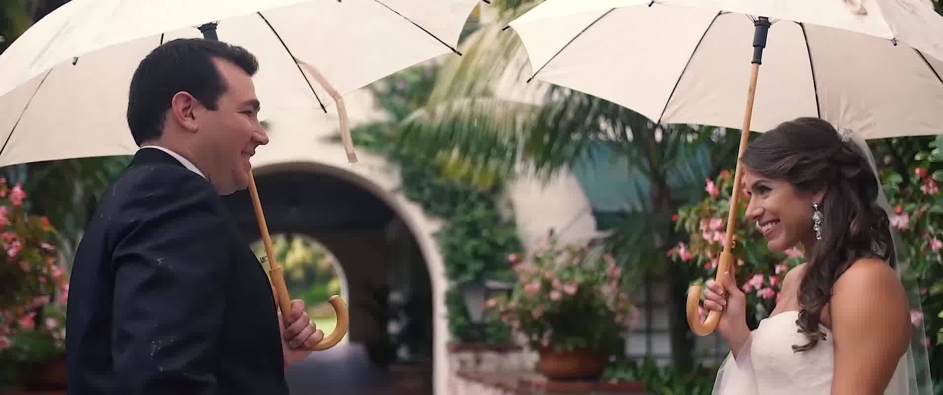 Couple during Palm Springs wedding photoshoot casual pose with holding umbrella